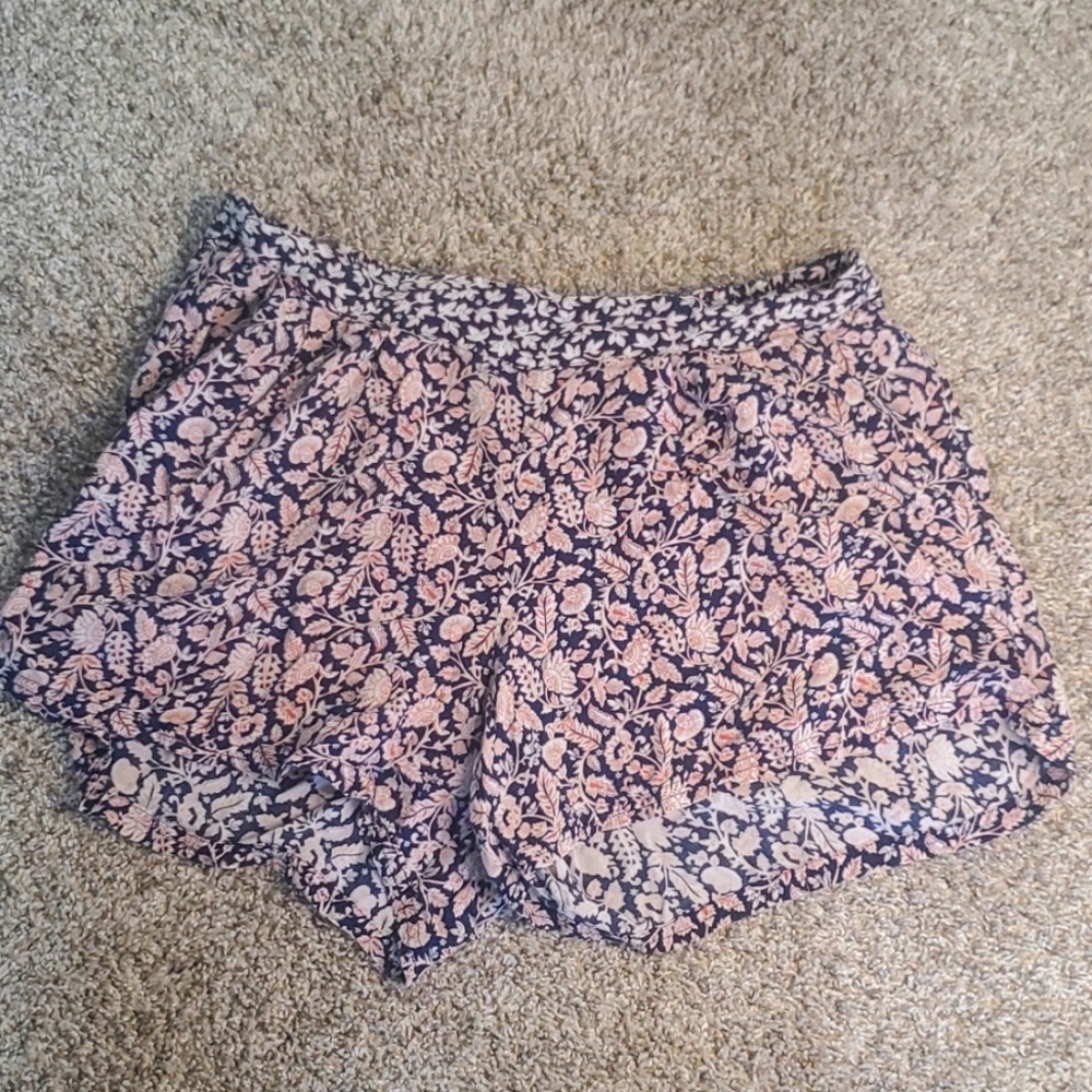 Navy shorts with pink leaf and flower design.